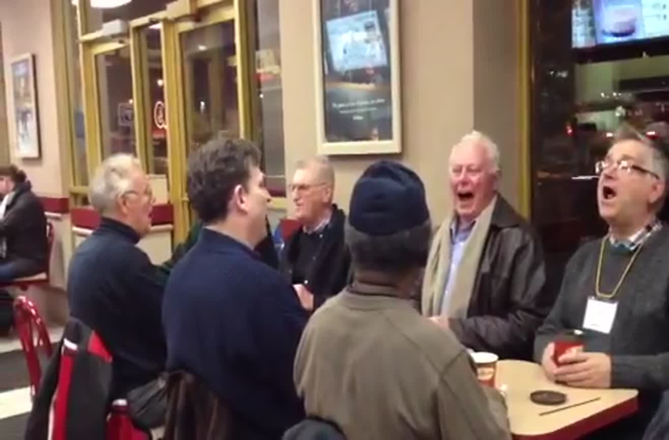 Men break into song at a Tim Hortons coffee shop.