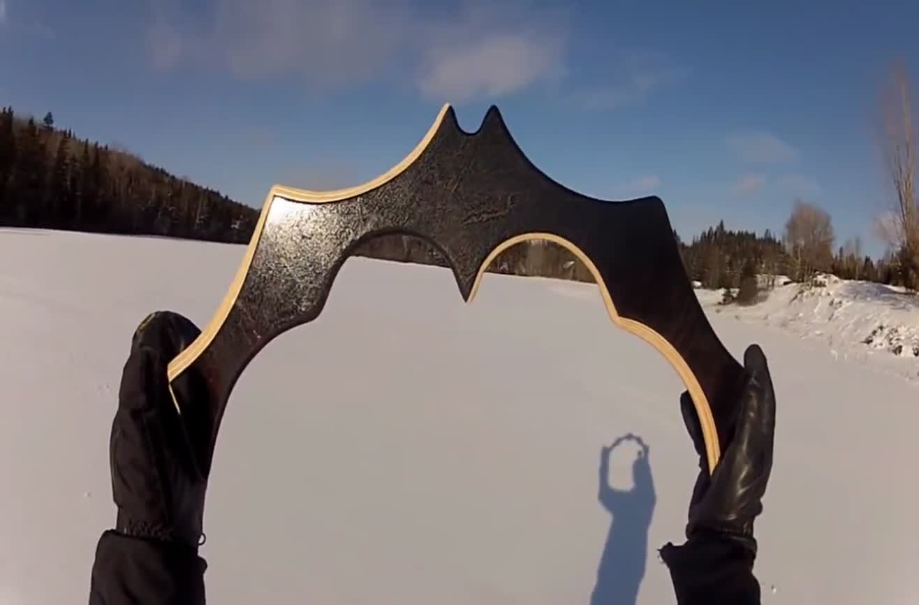 Man throws a handcrafted Batman boomerang.