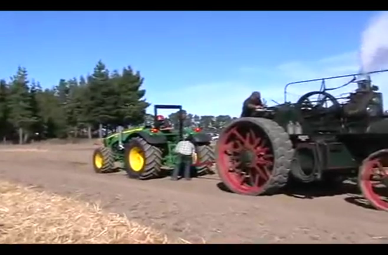 John Deere tractor vs. 1800s steam tractor.