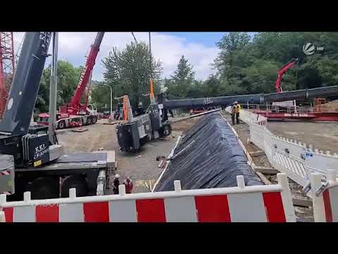 Crane rope breaks, nearly crushing two men.